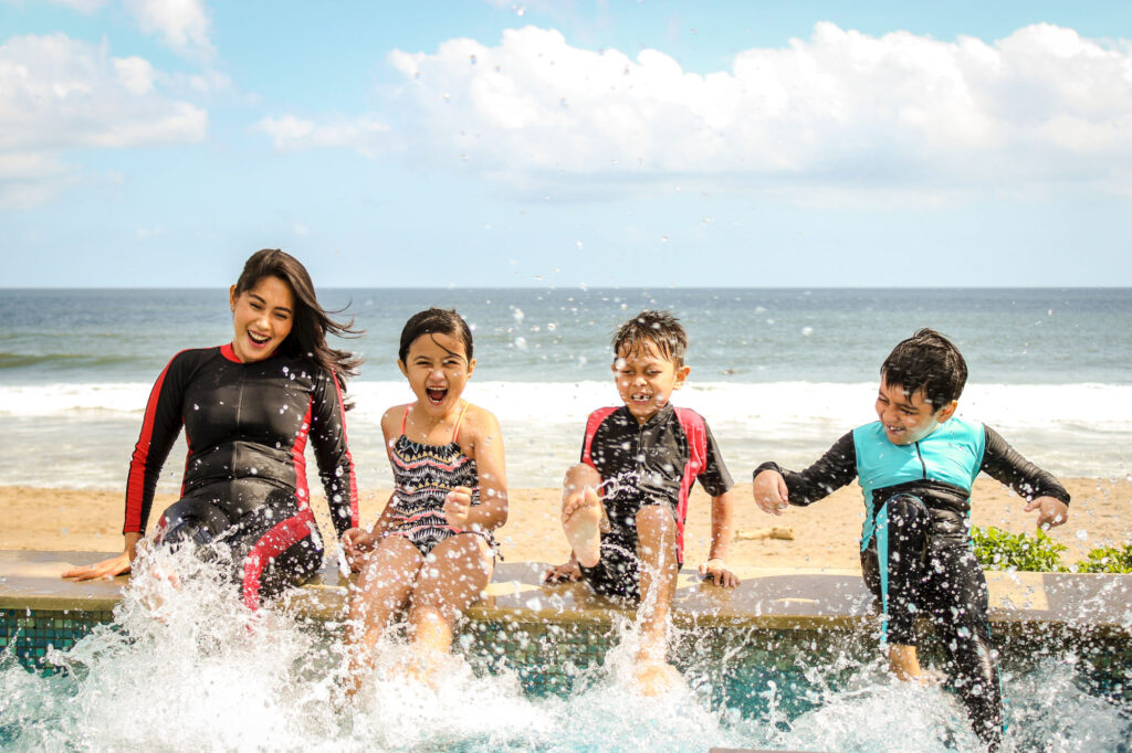 Children splashing on a beach vacation